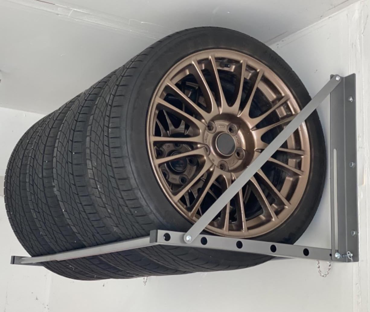 Maxxhaul 70489 Adjustable Wall Mount Folding Tire Storage Adjust from 32 to 48 Inches Wide up to 300 Lbs Capacity.