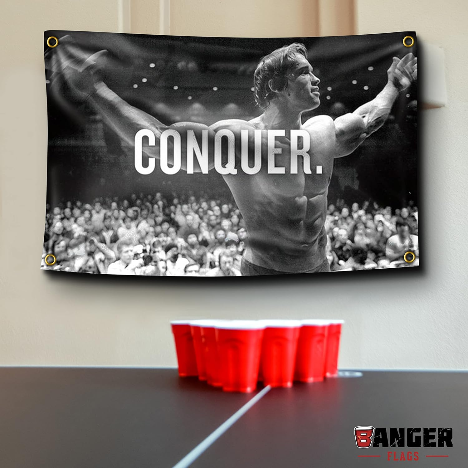 Banger Flags Banger - Original Arnold Schwarzenegger Conquer Motivational Inspirational Office Gym Dorm Wall Decor Design on a 3X5 Feet Flag with 4 Grommets for Easy Hanging. Authentic image number 1