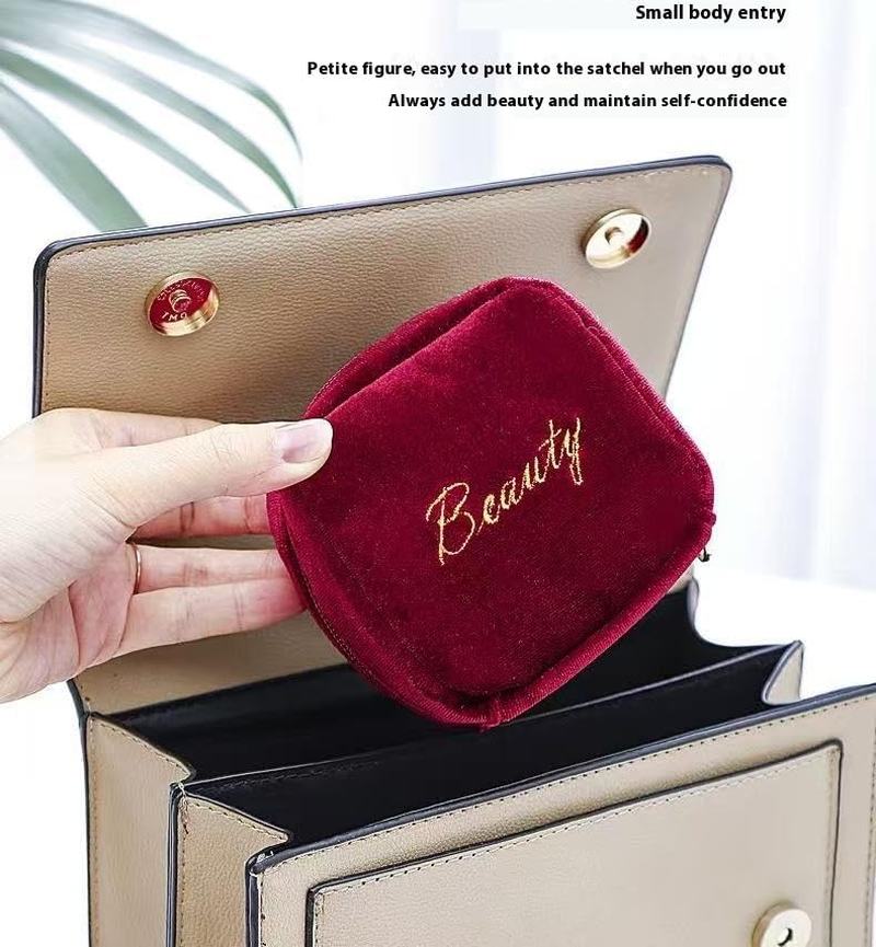 A Portable Beauty Companion This Burgundy Suede Hanging Bag Effortlessly Holds Items Such as Lipsticks and Earrings. image number 3