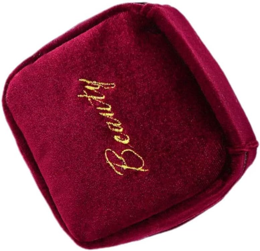 A Portable Beauty Companion This Burgundy Suede Hanging Bag Effortlessly Holds Items Such as Lipsticks and Earrings. image number 1